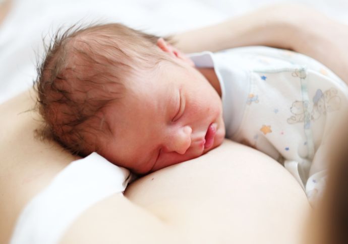 Neugeborenes Baby liegt auf der Mama