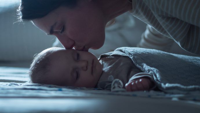 Mutter küsst ihr schlafendes Baby, Ab wann schlafen Babys durch, Baby durchschlafen