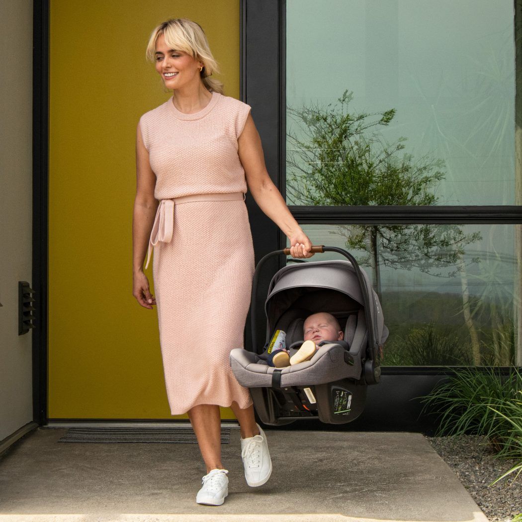 mutter traegt baby in nuna pipa next i-size